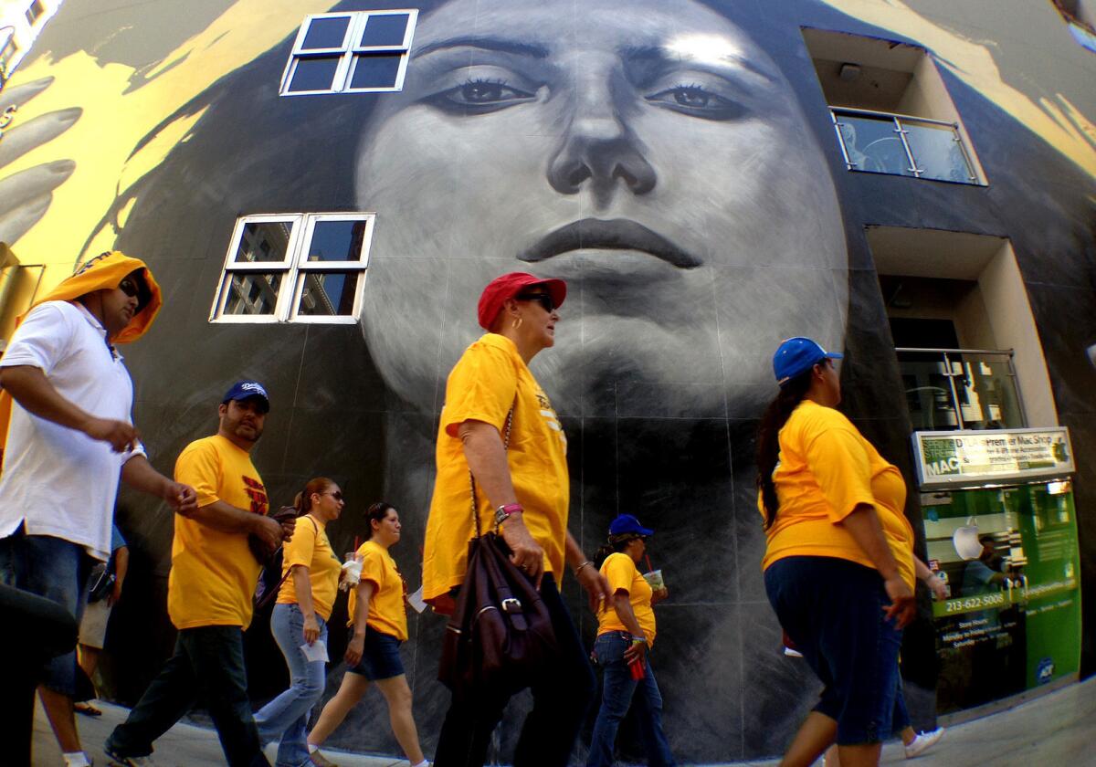 Labor-backed activists marched through downtown Los Angeles calling for better jobs.