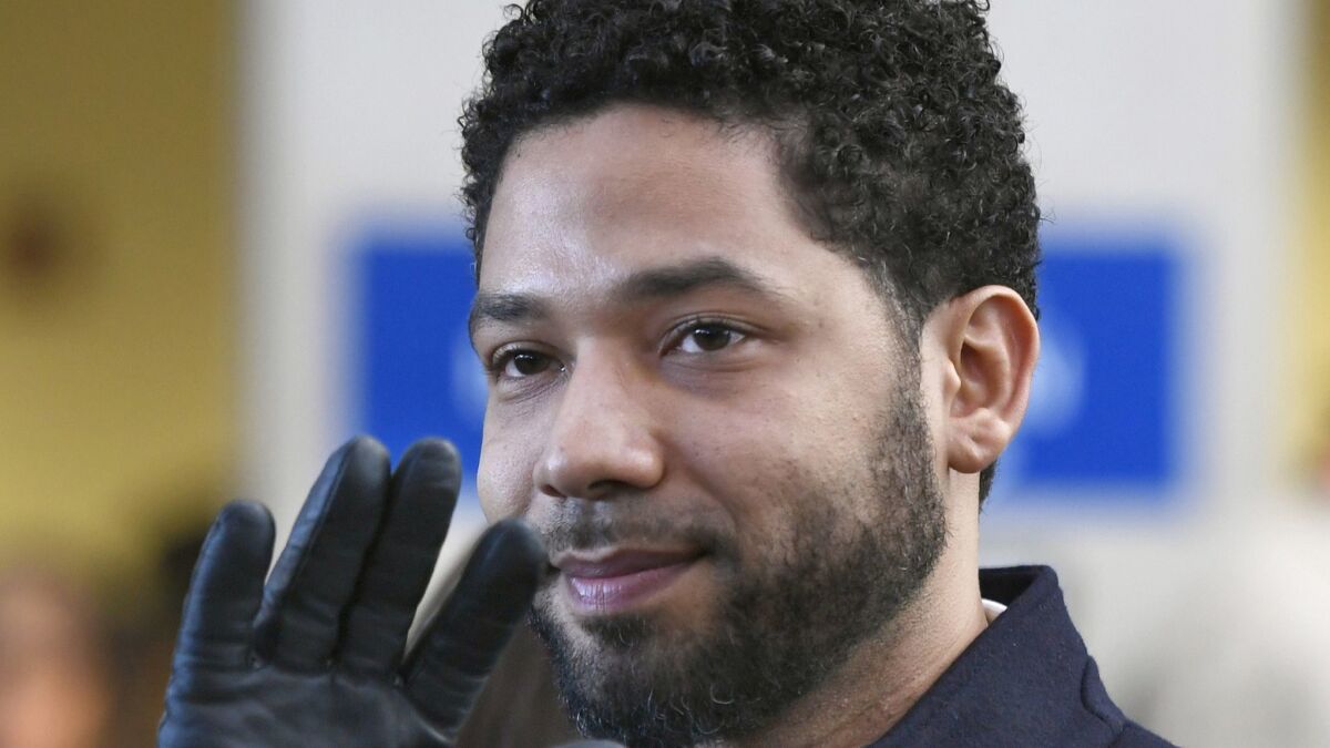 Jussie Smollett waves to supporters before leaving Cook County Court after his charges were dropped in Chicago on March 26.