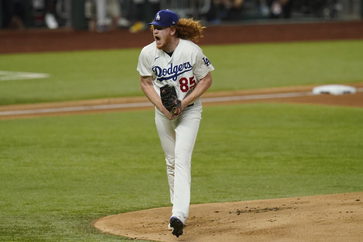 Dodgers starting pitcher Dustin May reacts after striking out Atlanta's Ozzie Albies during the first inning of Game 7.