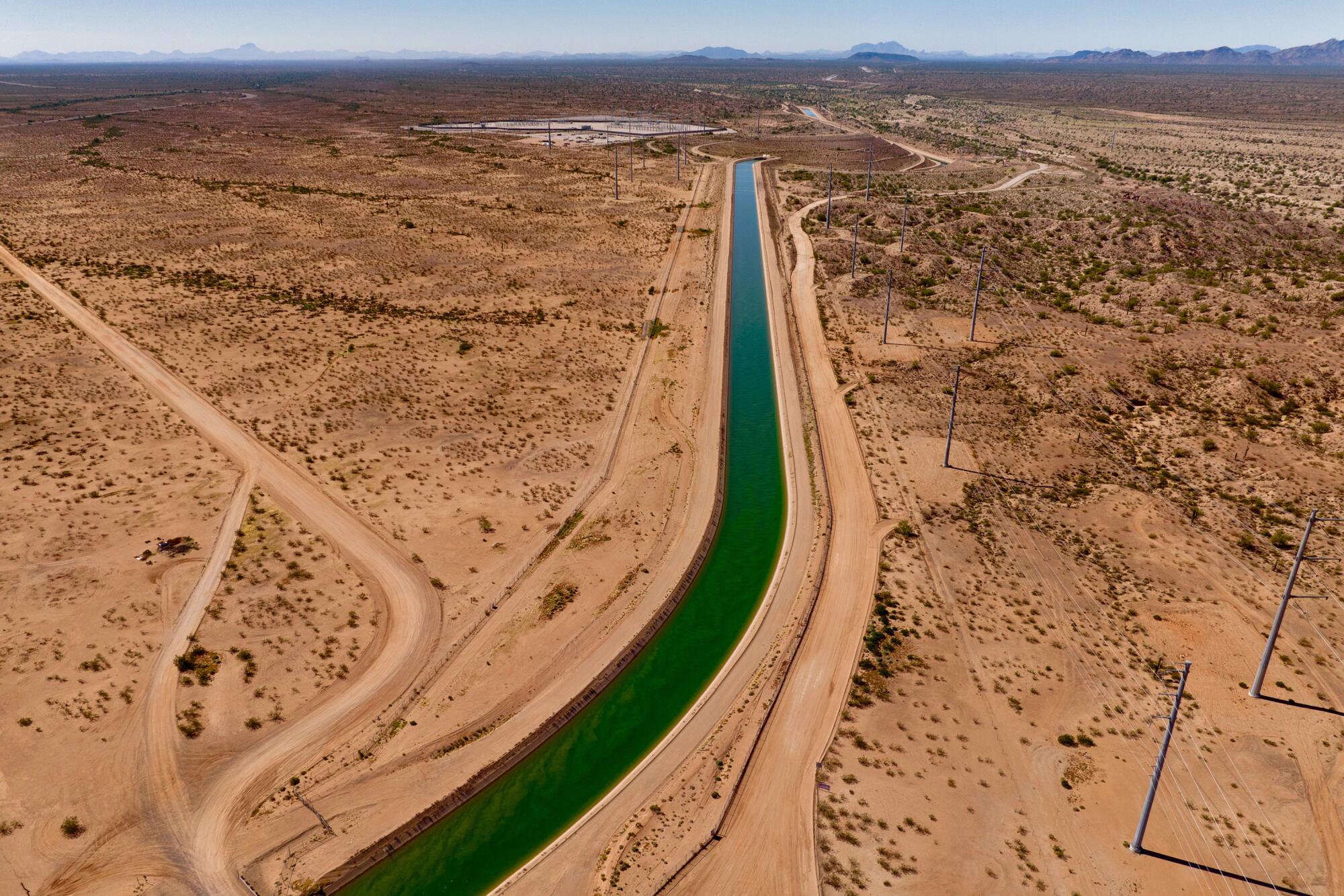 An overhead shot of a canal running through an arid landscape 
