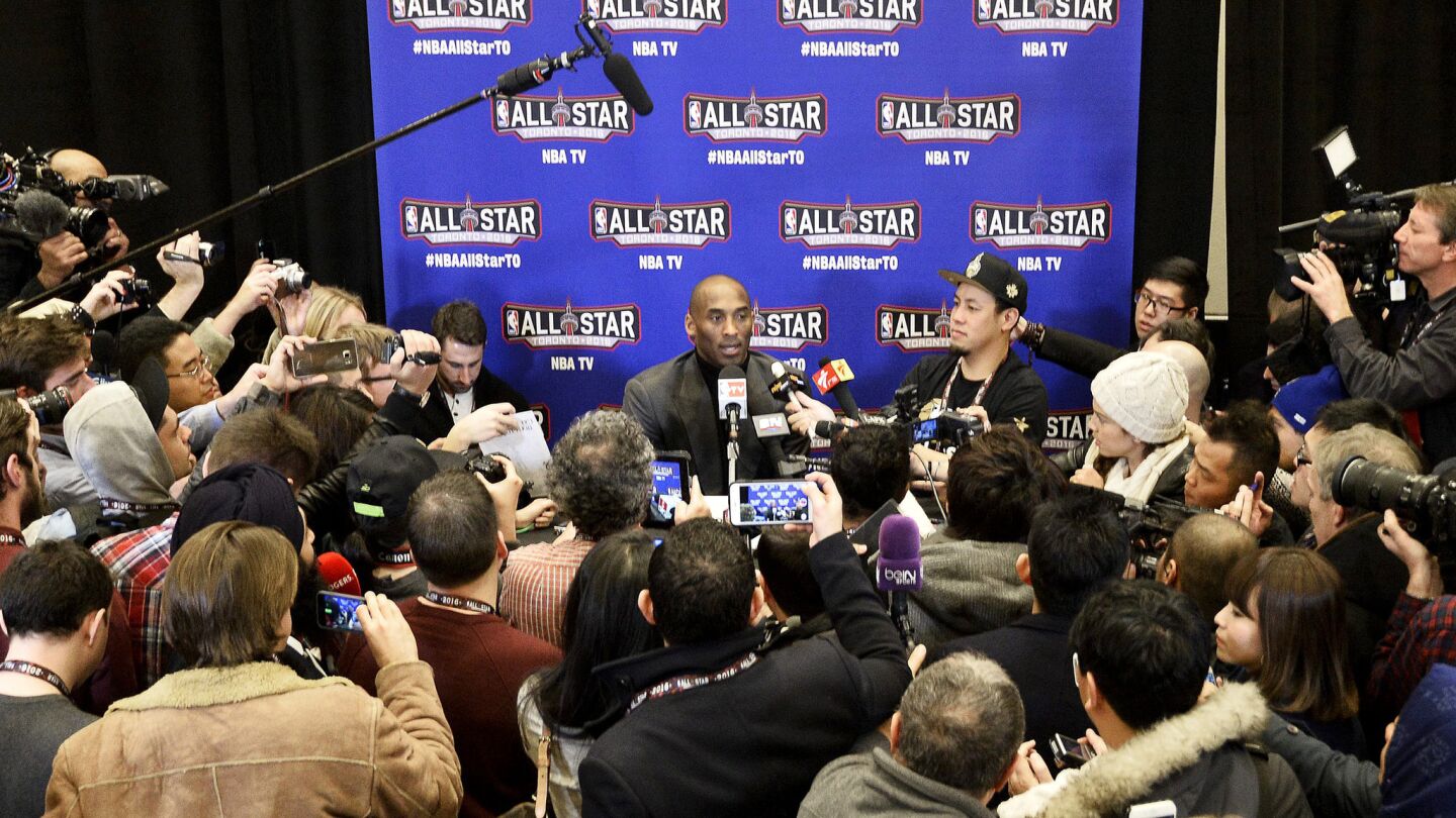 Lakers guard Kobe Bryant is engulfed by members of the media for his interview session Friday in Toronto.