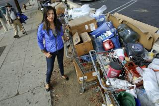 PANORAMA CITY, CA-NOVEMBER 13, 2014: Cindy Montanez, a candidate for Los Angeles city council, is photographed next to shopping carts, containing the belongings to homeless people on Parthenia St. in Panorama City on November 13, 2014. (Mel Melcon/Los Angeles Times)