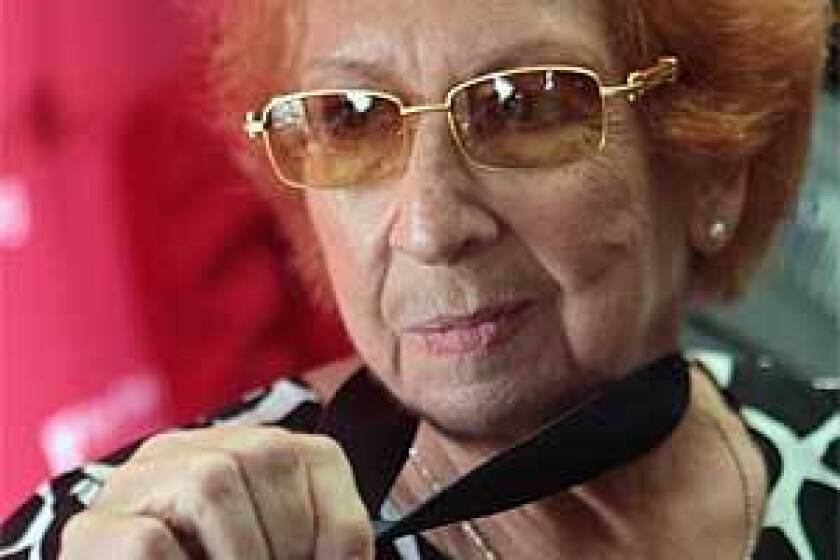 Kanokogi shows her gold medal for the 1959 New York State YMCA Judo Championships. Fifty years earlier she was stripped of the gold medal in the competition after judges realized she was a woman fighting against men.