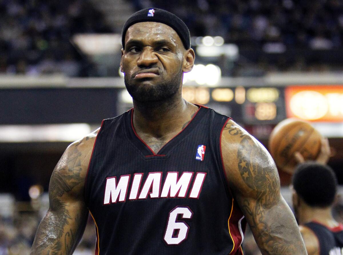 LeBron James is taking quite a while to decide between staying with Miami or going to Cleveland. Above, James in a December 2013 game.