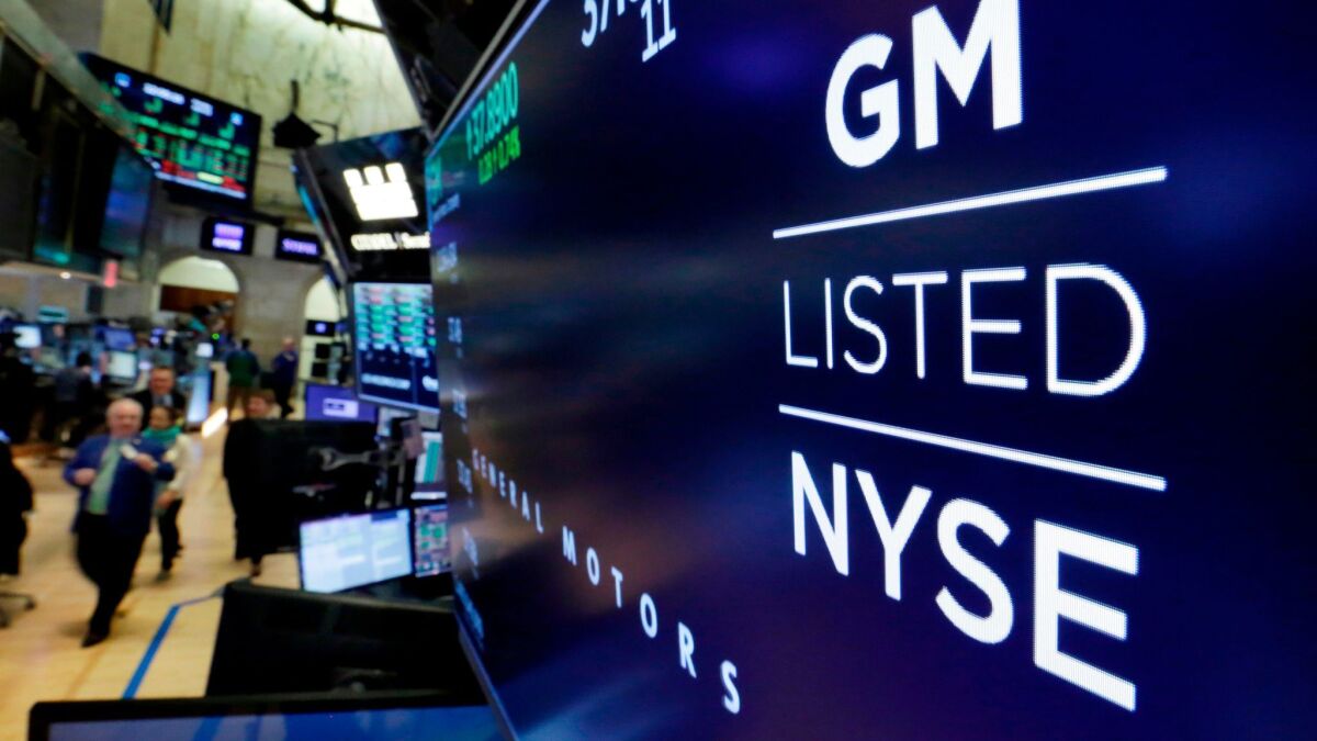 The logo for General Motors appears above a trading post on the floor of the New York Stock Exchange this year.
