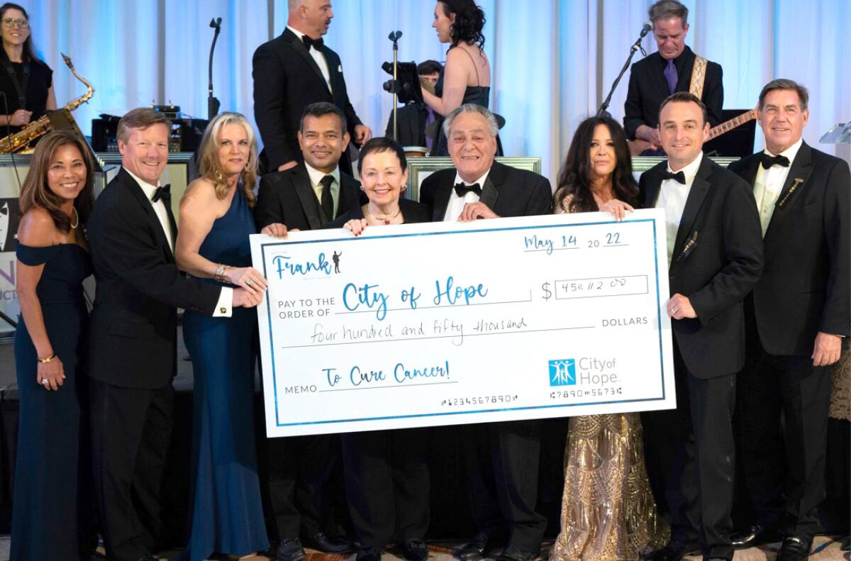 'Let's Be Frank About Cancer' gala committee presents a $450,000 check to City of Hope for cancer research.