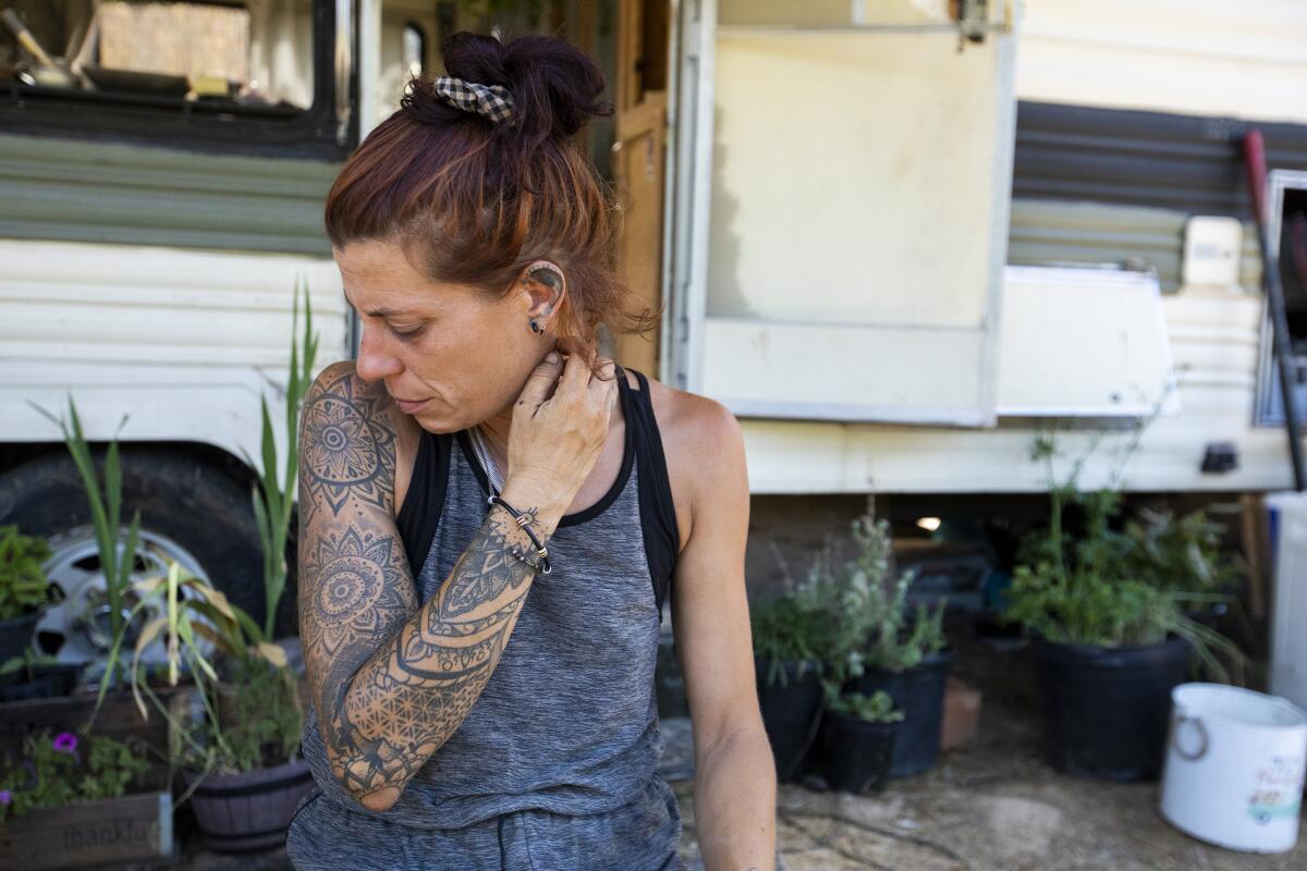 A woman outside a mobile home