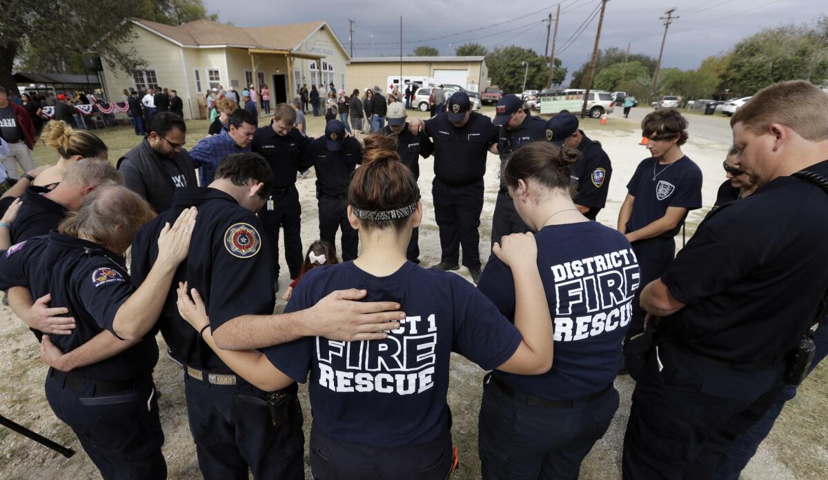First responders join in prayer following a Veterans Day event near the First Baptist Church Sutherland Springs in south Texas.