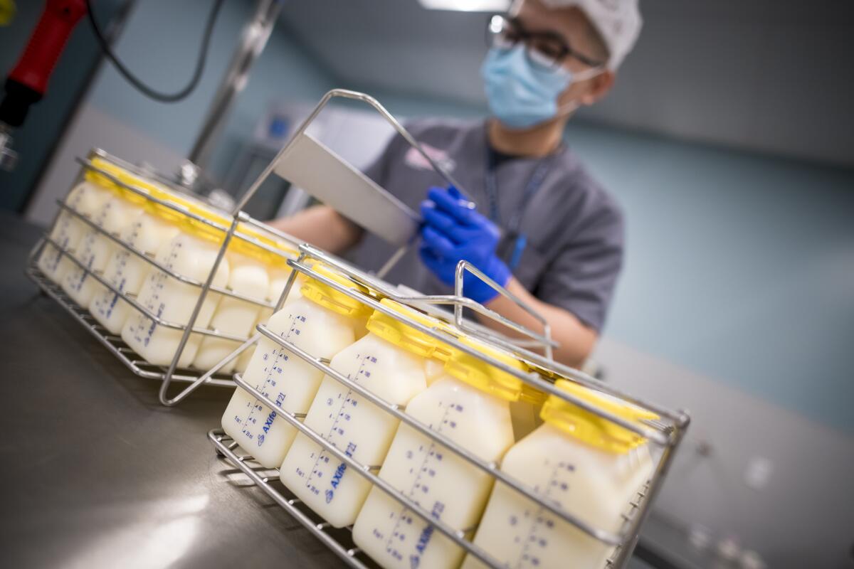 An employee transports bottles of donated breast milk at the University of California Health Milk Bank.