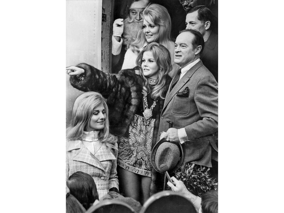Dec. 14, 1968: Bob Hope is joined by members of his troupe for his 18th Christmas trip to entertain servicemen overseas. From top to bottom: Santa, retired Air Force Gen. Emmett O'Donnell, singer Linda Bennett, actress Ann-Margret and Miss World Penelope Plummer.