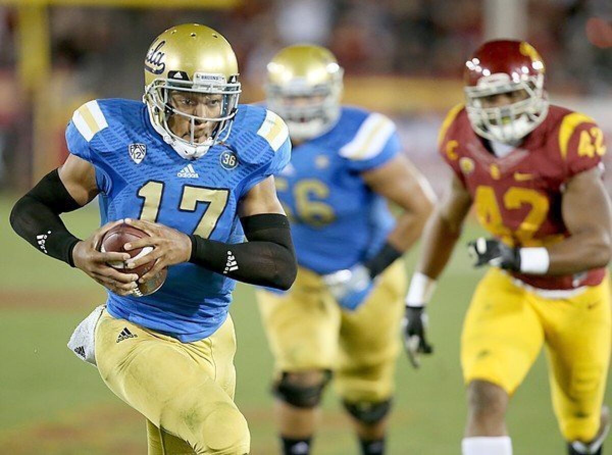 UCLA quarterback Brett Hundley tucks the ball and heads for the end zone during the third quarter of the Bruins' 35-14 win over USC last season.