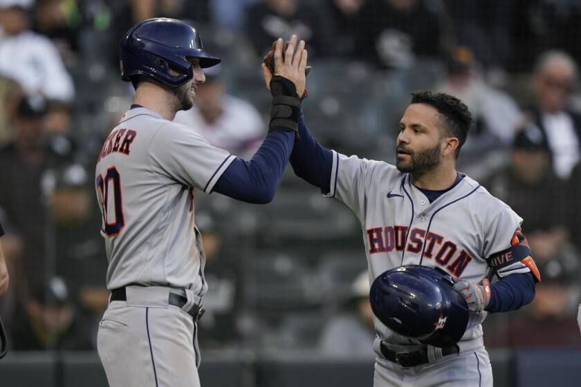Houston Astros second baseman Jose Altuve, right, celebrates his home run with Kyle Tucker (30) in the ninth inning during Game 4 of a baseball American League Division Series against the Chicago White Sox Tuesday, Oct. 12, 2021, in Chicago. (AP Photo/Nam Y. Huh)