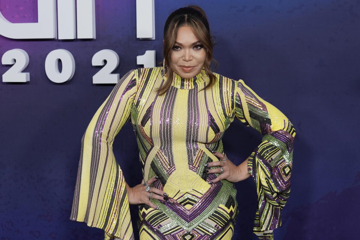 Tisha Campbell poses on arrival at an awards show.