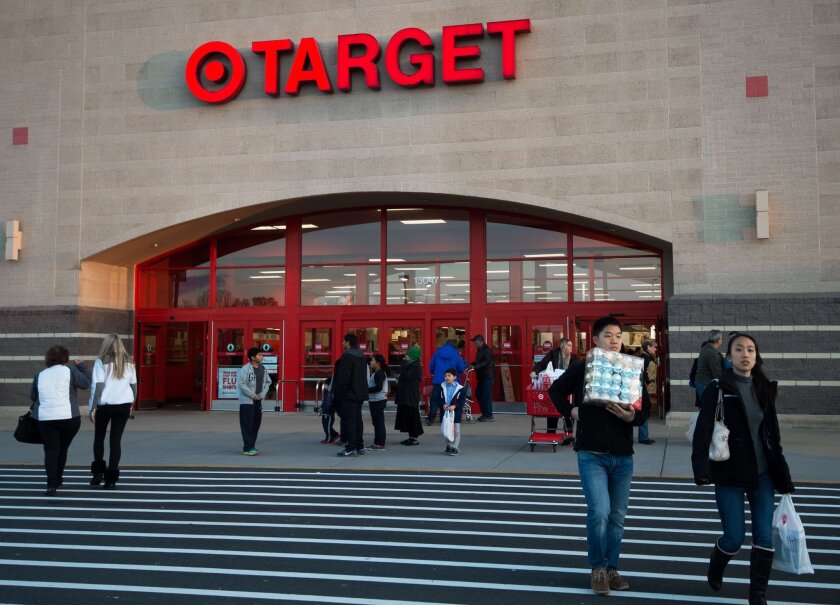 Shoppers leave the Target store in Fairfax, Va., on Nov. 28, 2014.