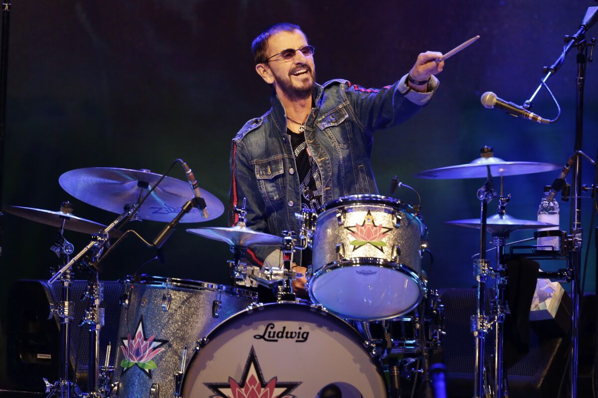 FILE - Ringo Starr plays as part of a concert celebrating the 50th anniversary of Woodstock in Bethel, N.Y., Friday, Aug. 16, 2019. Starr has tested positive for COVID-19, forcing the former Beatle to cancel several upcoming concerts in Canada with his All Starr Band. (AP Photo/Seth Wenig, File)