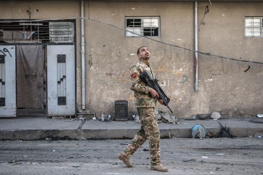 MOSUL, IRAQ - APRIL 07: An Iraqi Emergency Response Division soldier looks to the sky after hearing a noise believed to be from an Islamic State drone during fighting in west Mosul on April 7, 2017 in Mosul, Iraq. Iraqi forces backed by U.S and British air support have entered their sixth month of fighting as they continue the battle to retake the country's second largest city from Islamic state who have held it since 2014. (Photo by Carl Court/Getty Images) ** OUTS - ELSENT, FPG, CM - OUTS * NM, PH, VA if sourced by CT, LA or MoD **