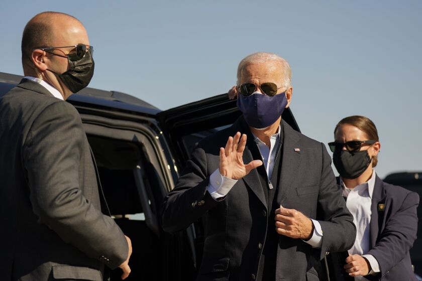 Democratic presidential candidate former Vice President Joe Biden waves before boarding his campaign plane at the New Castle Airport in New Castle, Del., Sunday, Oct. 18, 2020, en route to Durham, N.C. (AP Photo/Carolyn Kaster)