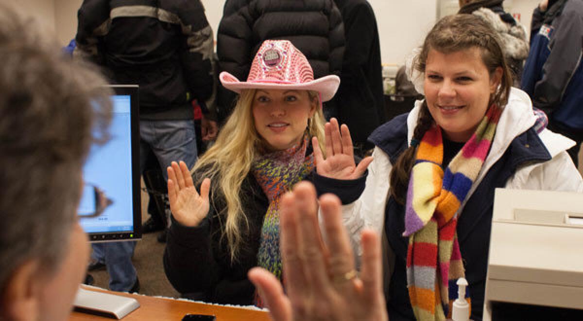 Corrinalyn and Jennifer Guyette apply for a marriage license at the King County Recorder's Office in Seattle, Washington.