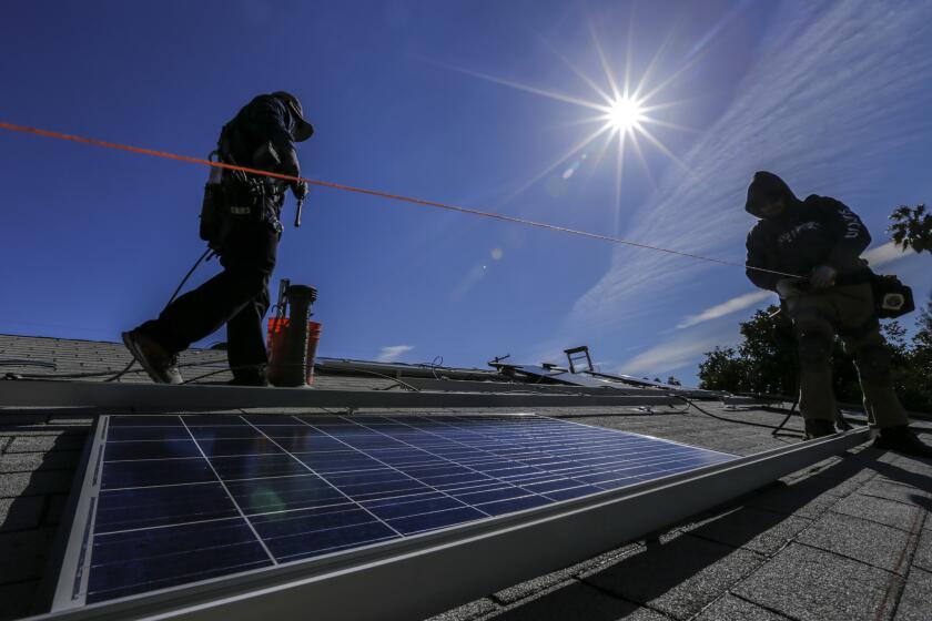 A crew from Sunrun home solar company installs solar panels on a home in Van Nuys.