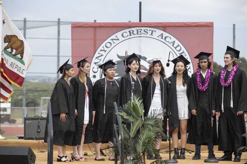 Students sing the National Anthem at the 2023 Graduation