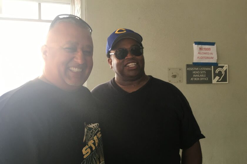 Narbonne Coach Manuel Douglas (left) and Crenshaw Coach Robert Garrett are all smiles before City Section football coaches meeting on Saturday.