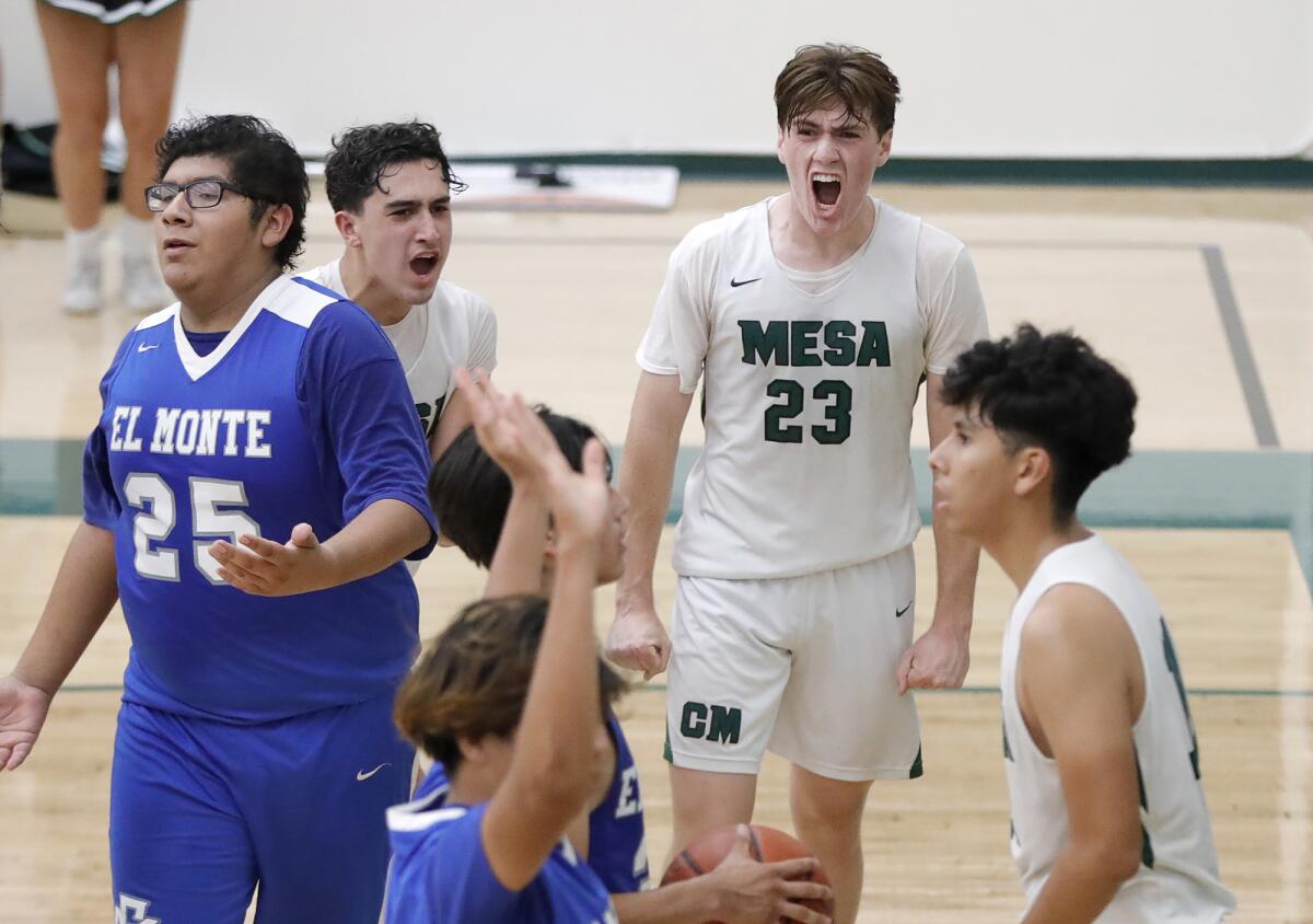 Blake Wolf (23) reacts to a Costa Mesa basket by teammate Gio Quero, far right, during the quarterfinals against El Monte.