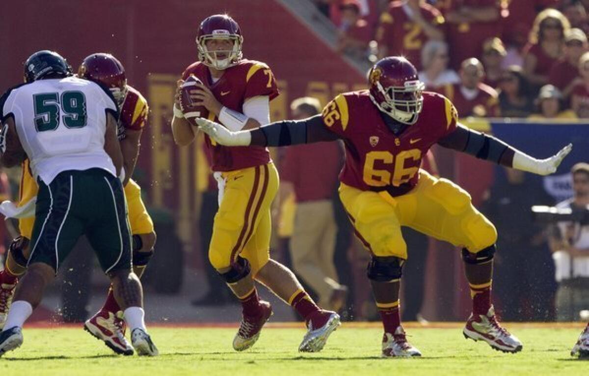 USC guard Marcus Martin (66) gives quarterback Matt Barkley (7) plenty of time to look for an open receiver against Hawaii on Sept. 1.