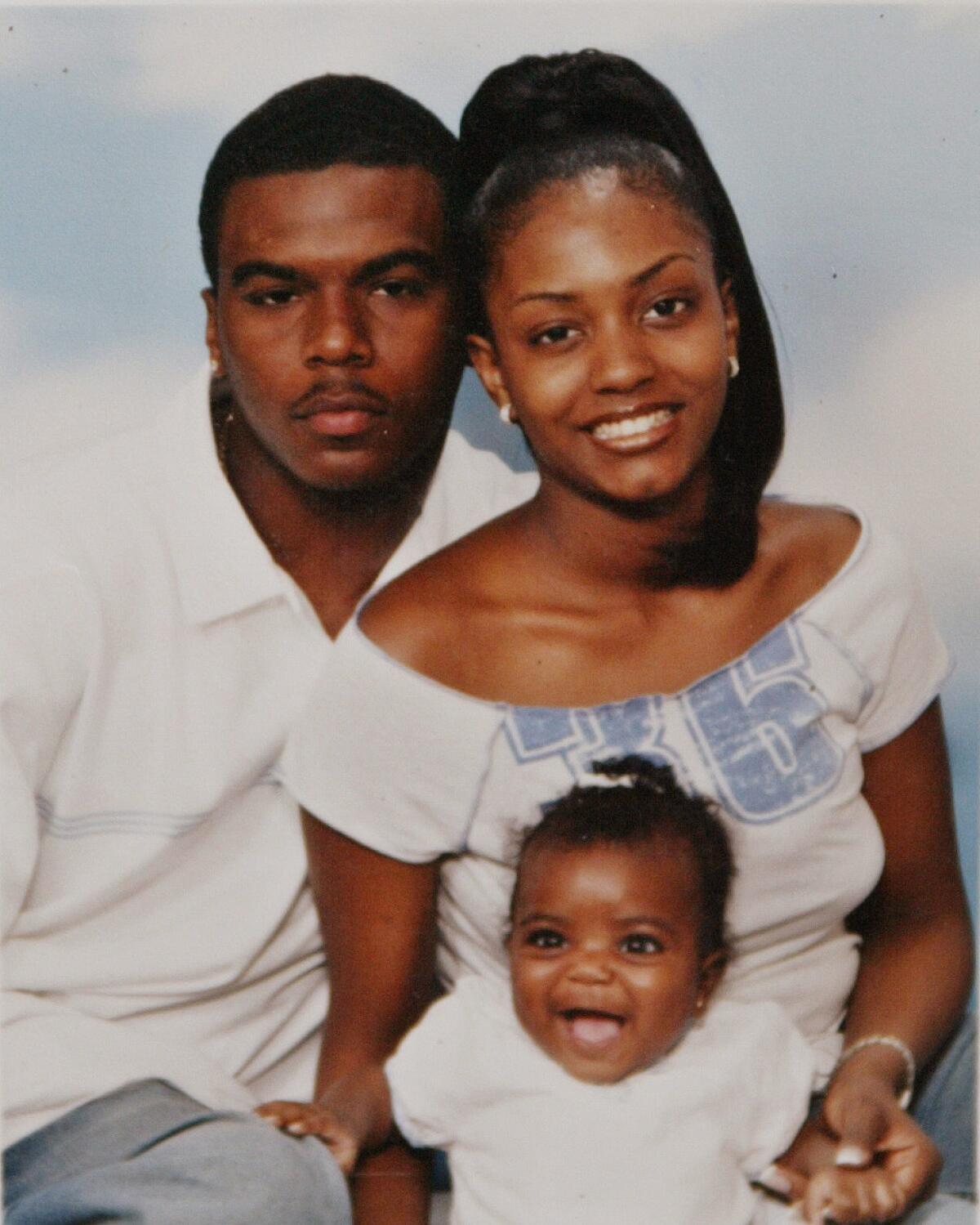 In this undated family photo, Sean Bell and his fiancee, Nicole Paultre, pose with their daughter. (The Daily News via AP)