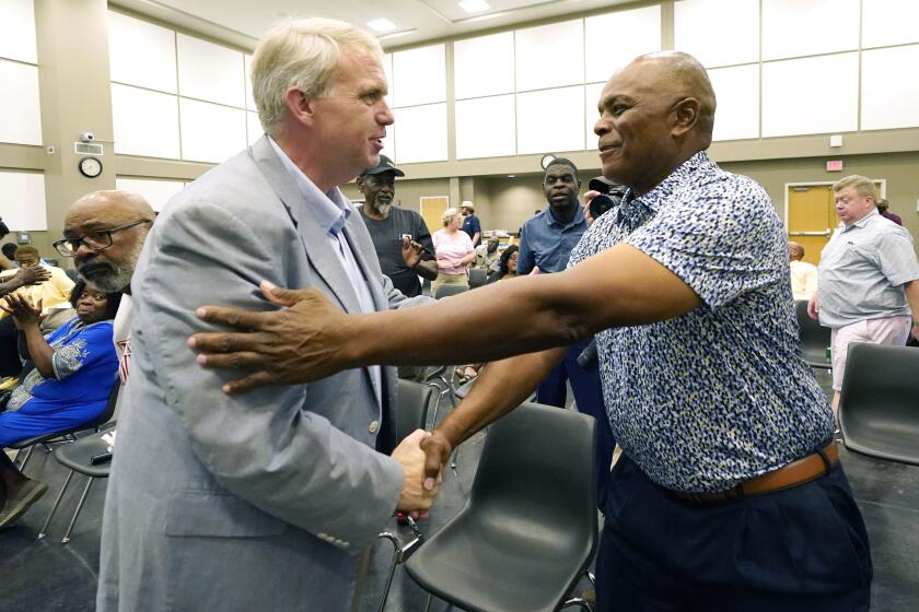 Northern District Public Service Commissioner Brandon Presley, the Democratic candidate for governor in November, left, greets Oliver Bates of Tylertown, during a campaign stop in Summit, Miss., Thursday, Sept. 14, 2023. (AP Photo/Rogelio V. Solis)