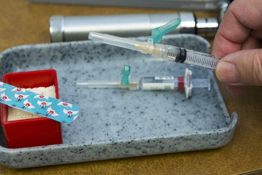 In this Thursday, Jan. 29, 2015, photo, a single-dose of the measles-mumps-rubella virus vaccine live, or MMR vaccine is ready at the practice of Dr. Charles Goodman in Northridge, Calif. The measles-mumps-rubella vaccine, or MMR, is 99 percent effective at preventing measles, which spreads easily through the air and in enclosed spaces. Symptoms include fever, runny nose, cough and a rash all over the body. (AP Photo/Damian Dovarganes)