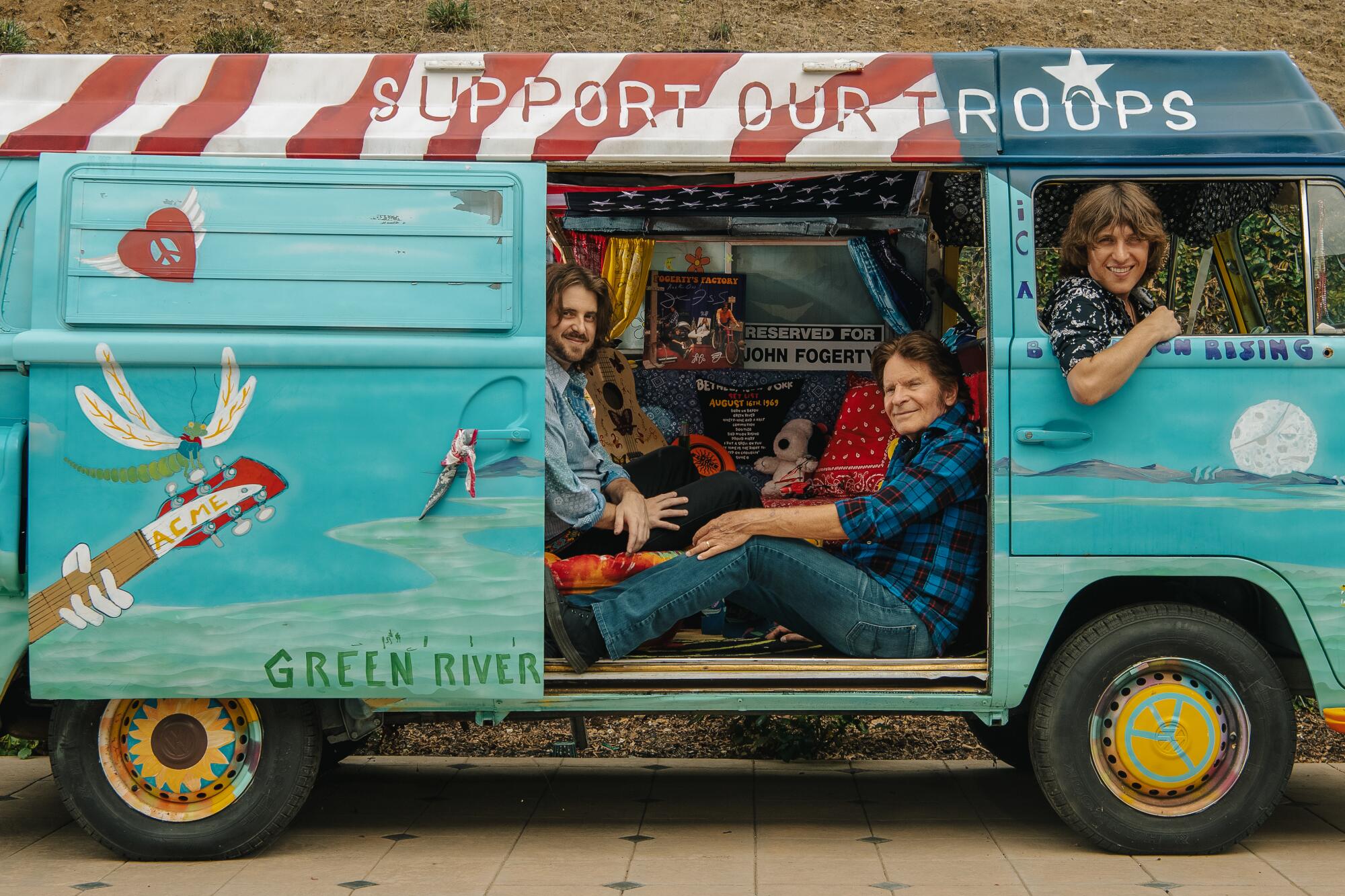 Three rock musicians in a customized old van