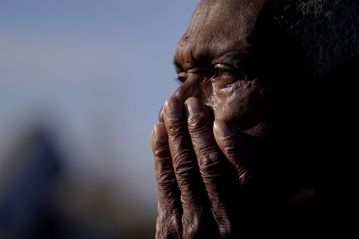 Ezell Williams cries while talking about the damage caused to his properties and those of his neighbors, Sunday, March 26, 2023, in Rolling Fork, Miss., where a tornado swept through the town two days earlier. Emergency officials in Mississippi say several people have been killed by tornadoes that tore through the state on Friday night, destroying buildings and knocking out power as severe weather produced hail the size of golf balls moved through several southern states. (AP Photo/Julio Cortez)