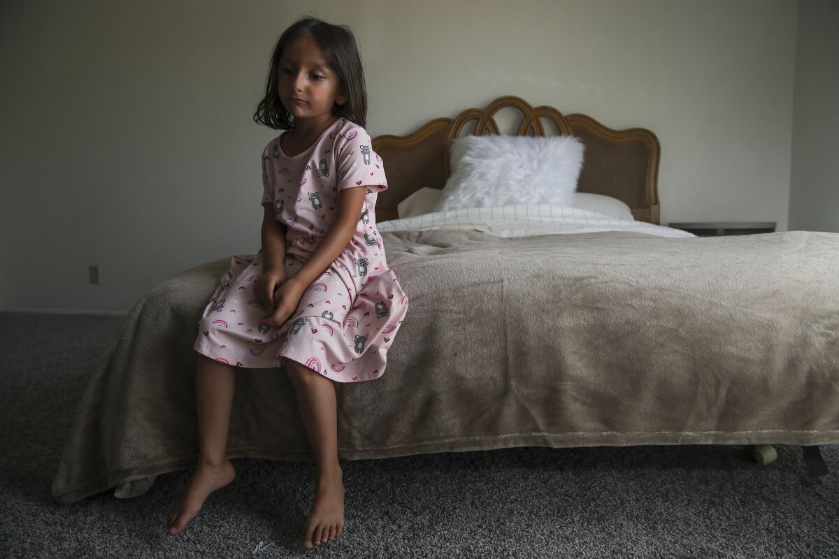 Afghan refugee Aqsa Sadat, 6, sits on a bed provided by members of the group Helping El Cajon Refugees.