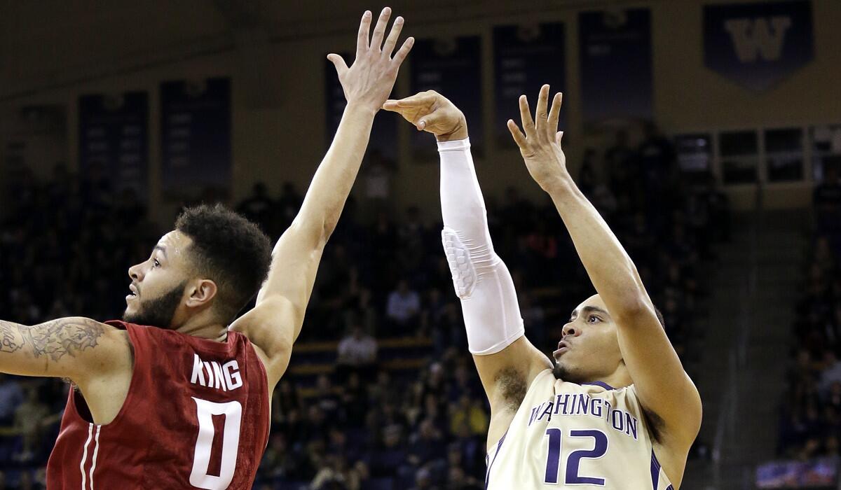 Washington's Andrew Andrews, right, shoots over Washington State's Derrien King during the second half on Wednesday.