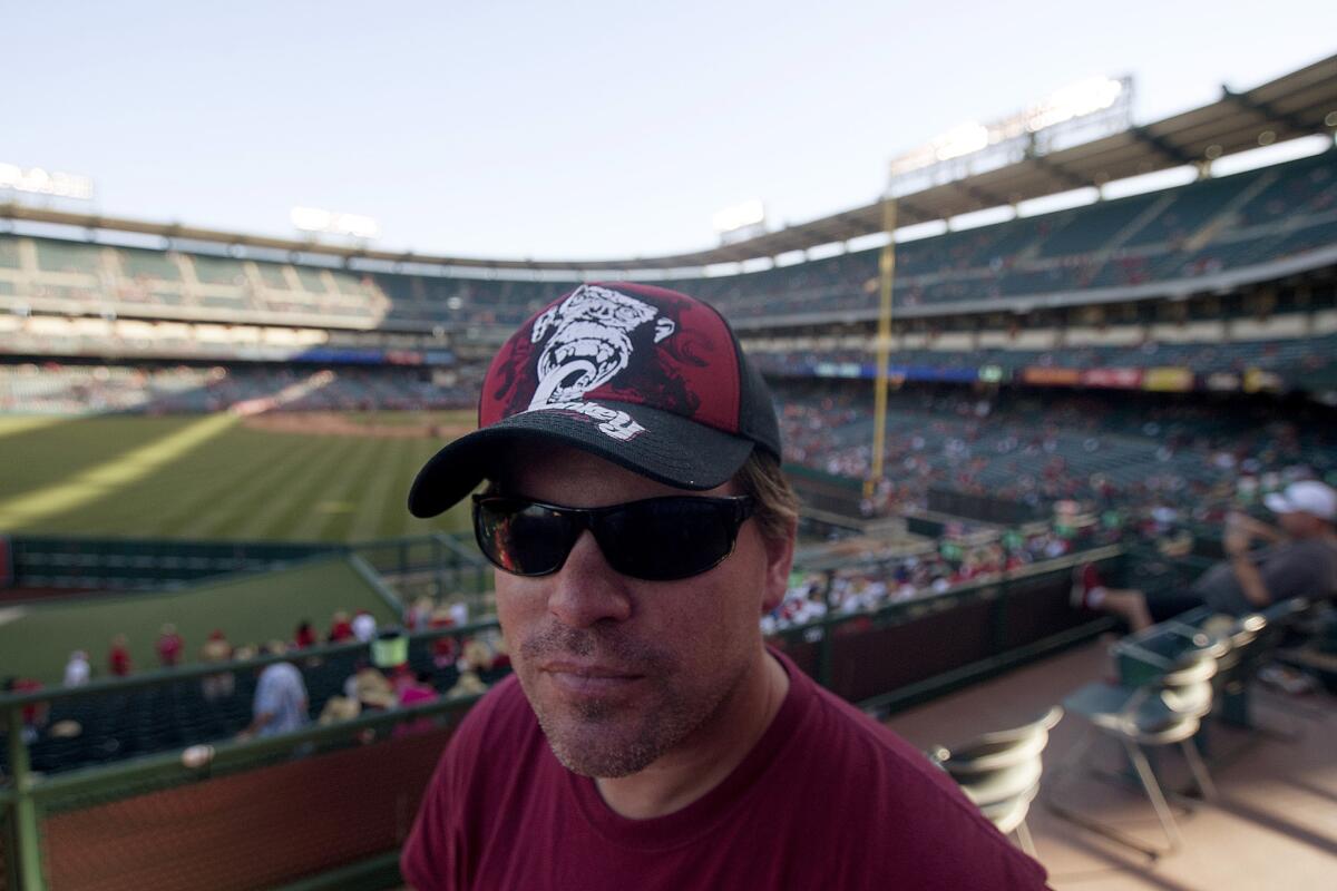 Chuck Booth, a resident of Vancouver, Canada attends a baseball game between the Angels and the Houston Astros on Tuesday as part of his quest to attend some 200 baseball games at all 30 ballparks.