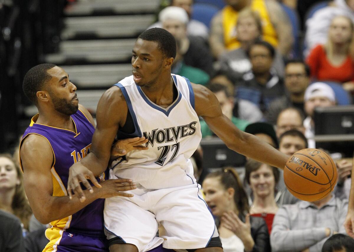 Timberwolves forward Andrew Wiggins tries to back down Lakers guard Wayne Ellington in the first half of a game Dec. 14.
