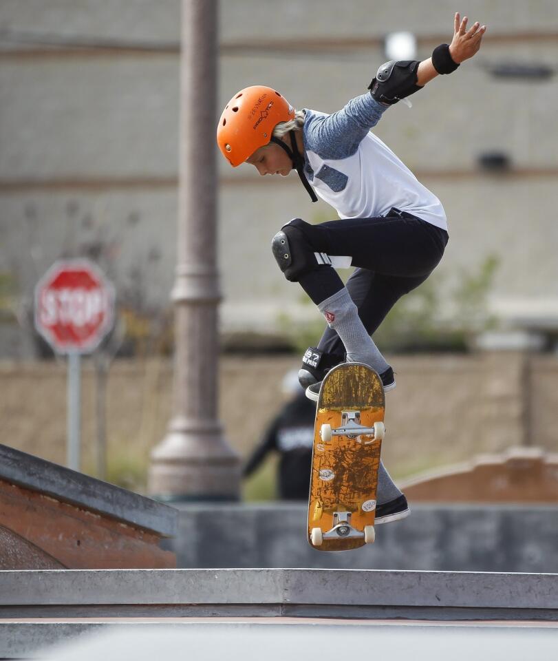 Elijah Anderson, 13, who is wearing a sensor chest and data recorder on his right wrist, jumps while riding his skateboard at the Encinitas Community skateboard park.