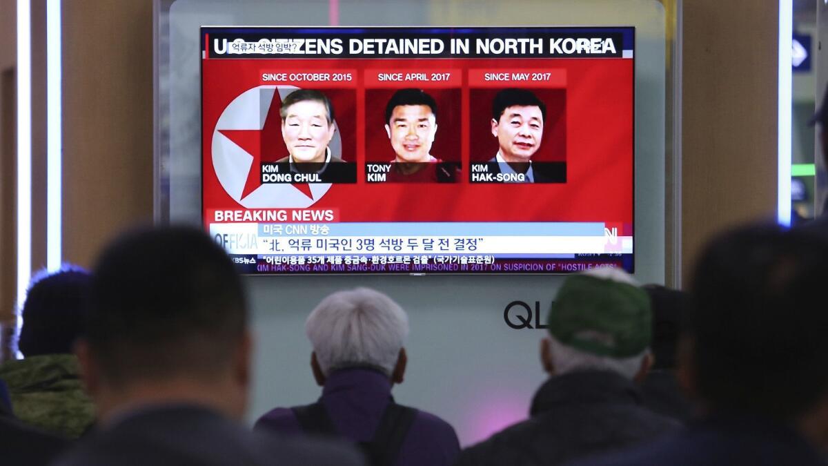 South Koreans at a rail station in Seoul on May 3 watch a news report on three Americans who were detained by North Korea