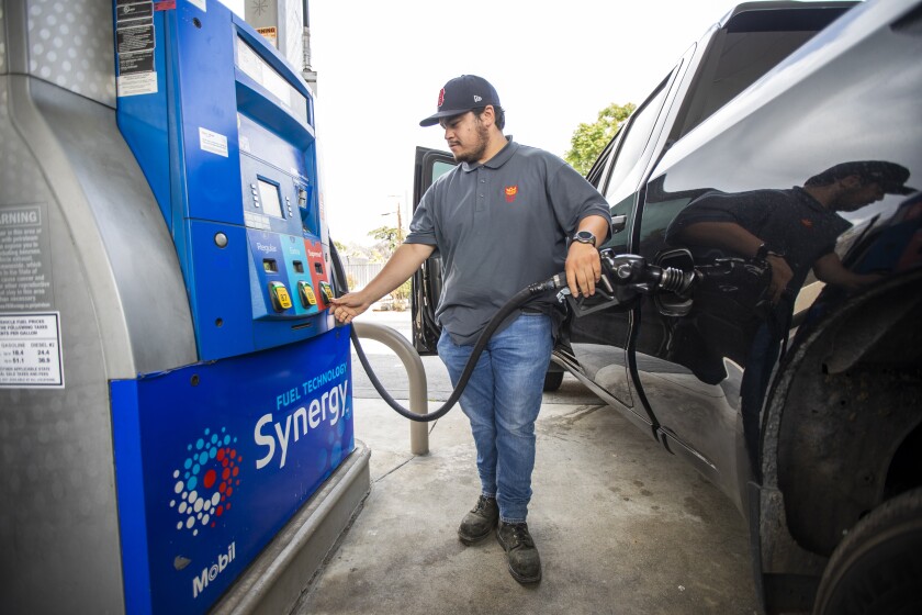 Mario Beccera fills up his gas tank at a Mobil gas station in April.