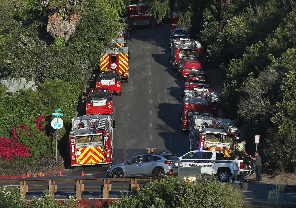 Firefighting apparatus park along Rancho Laguna Drive in Bluebird Canyon Drive during Rancho fire on Monday.
