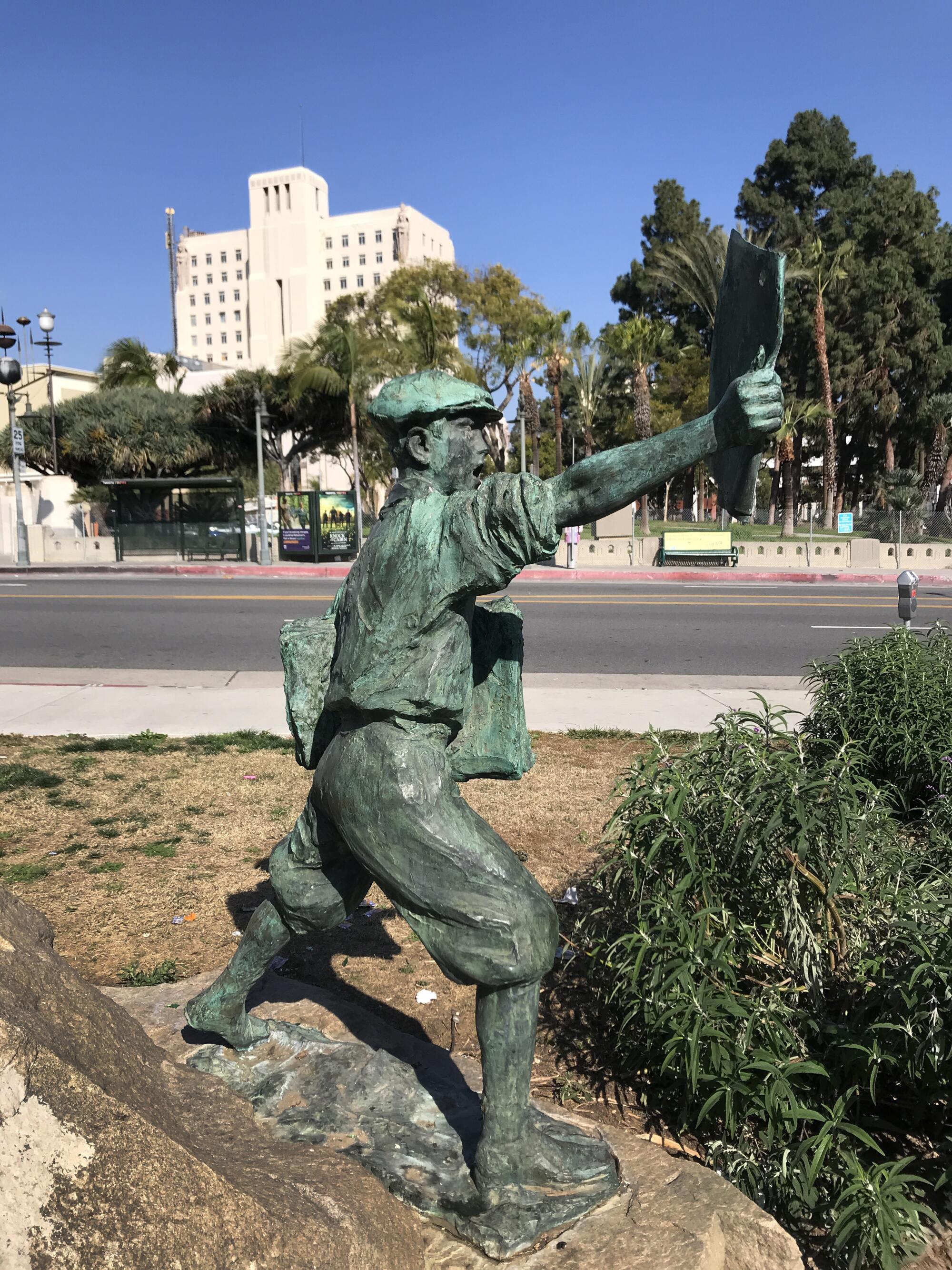 The statue of the Newspaper boy, which stands next to 