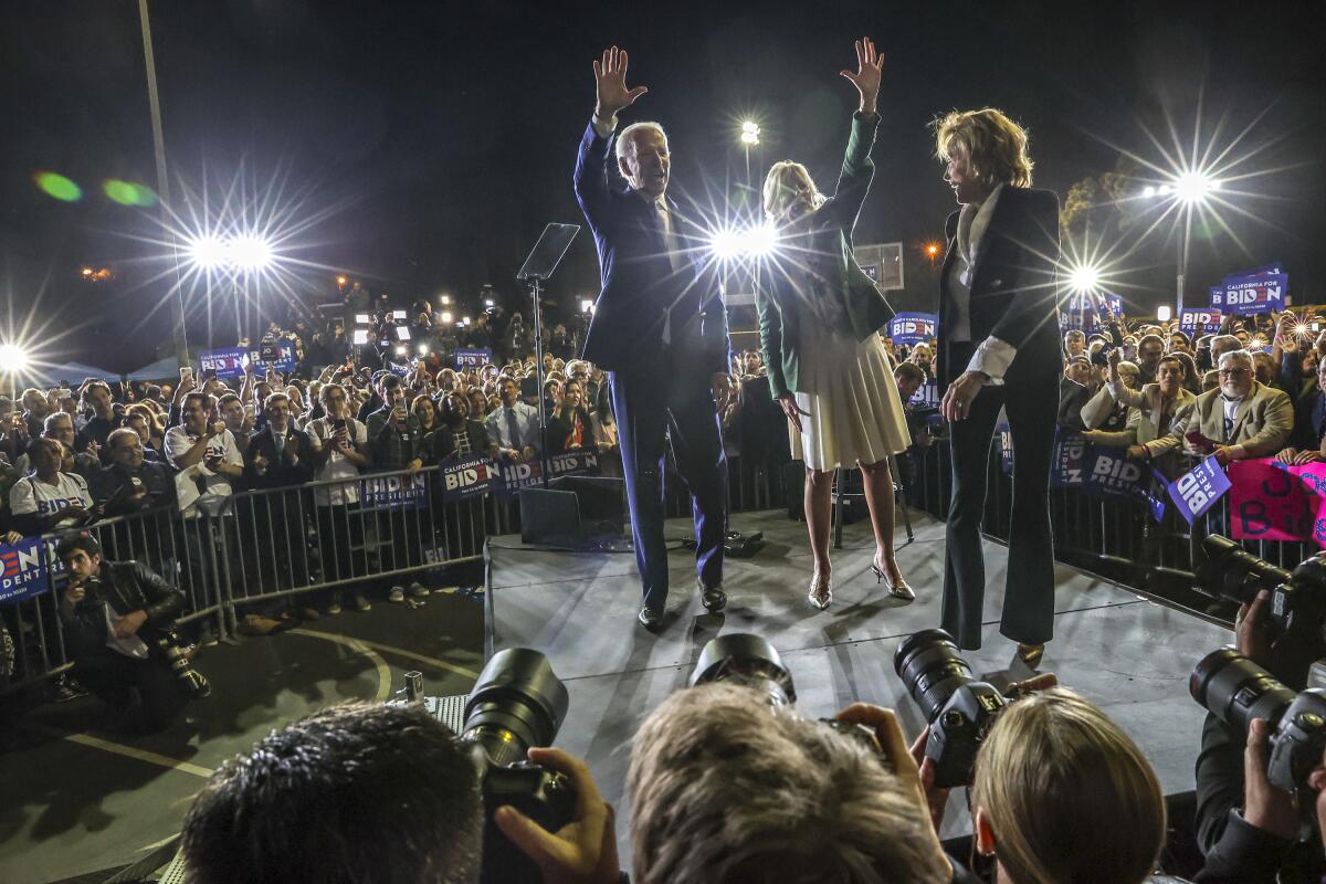 Joe Biden enters the stage with his wife, Jill and sister, Valerie, far right at the Baldwin Hills Recreation Center on Tuesday night.
