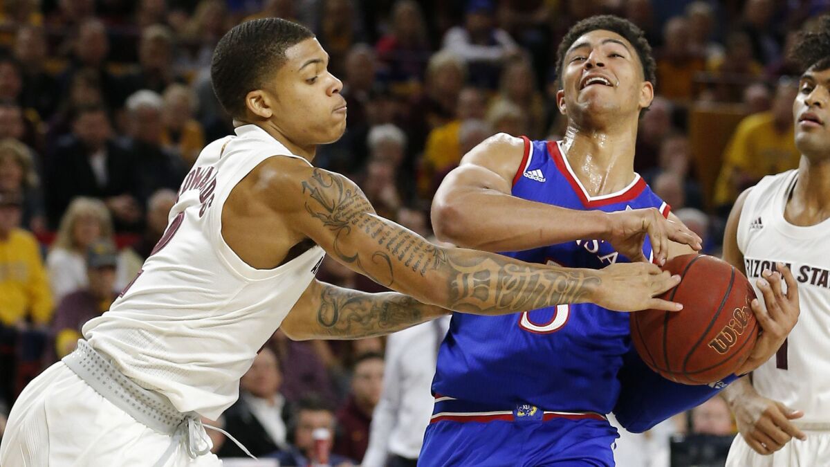 Arizona State guard Rob Edwards, left, knocks the ball away from Kansas guard Quentin Grimes during the first half.