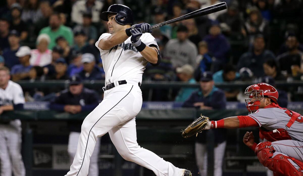 Seattle Mariners' Jesus Montero watches his three-run home run against the Angels during the fourth inning on Wednesday.