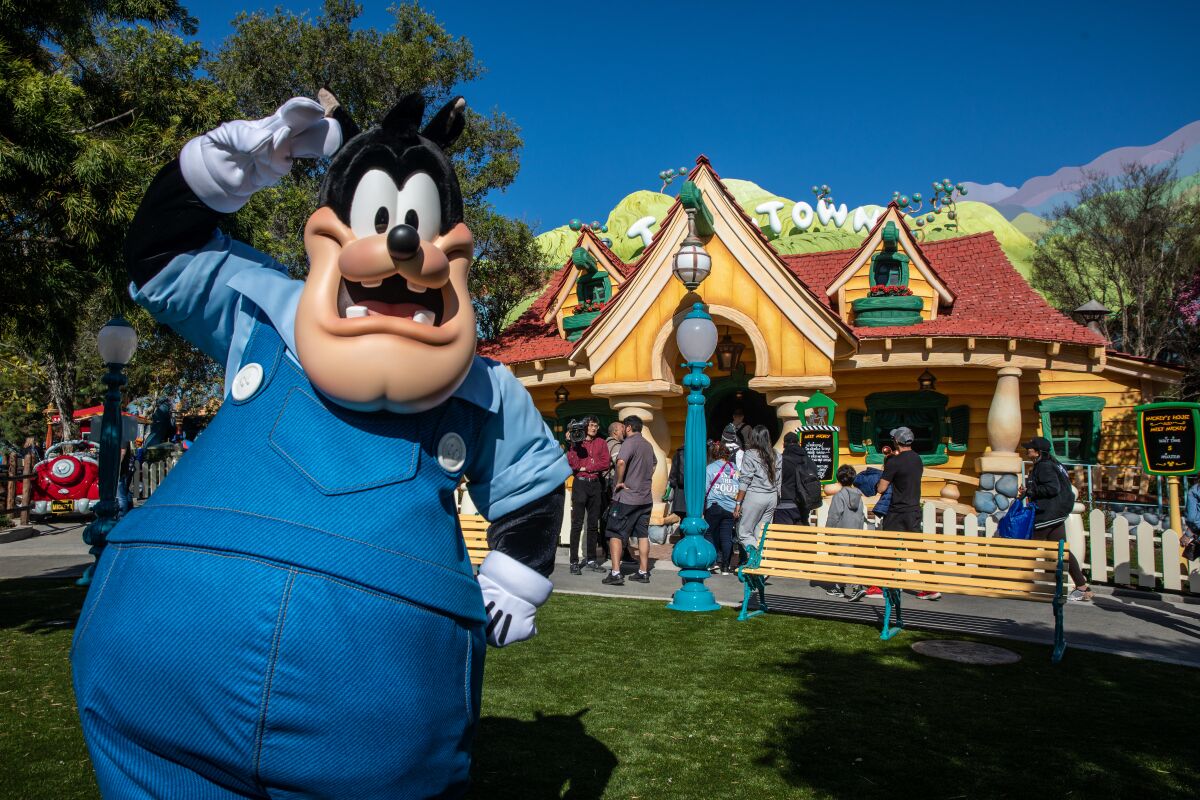 Disney character Pete raises his arm at Toontown