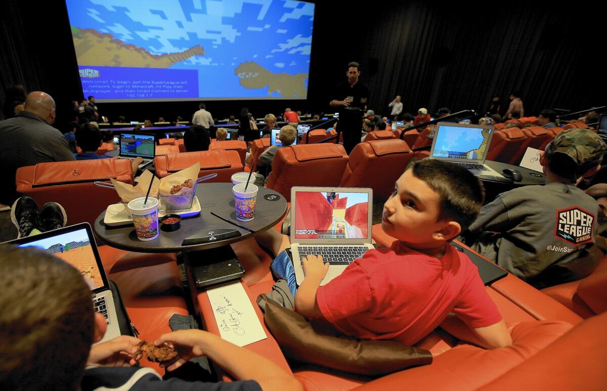 Fans of the video game "Minecraft" gather at the iPic theater in Westwood for an event sponsored by Super League Gaming.
