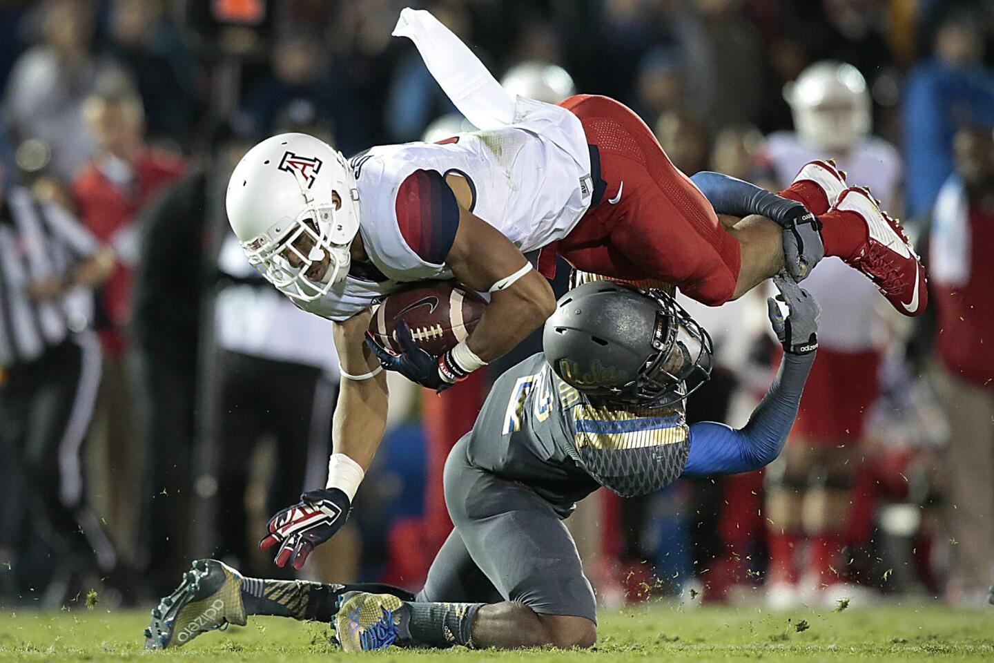 Bruins defensive back Jaleel Wadood brings down Wildcats receiver Trey Griffey in the fourth quarter.