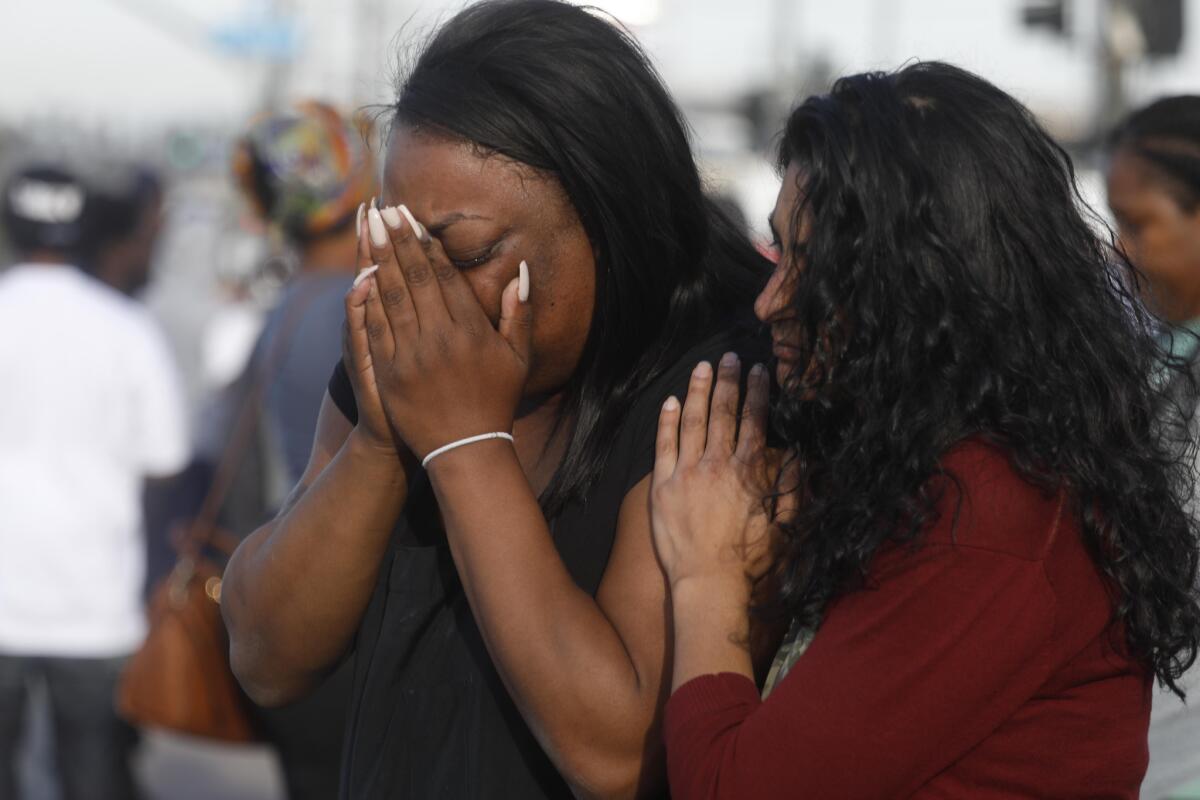 Marquesa Lawson mourns the shooting death of rapper Nipsey Hussle outside his store in South Los Angeles. (Genaro Molina / Los Angeles Times)