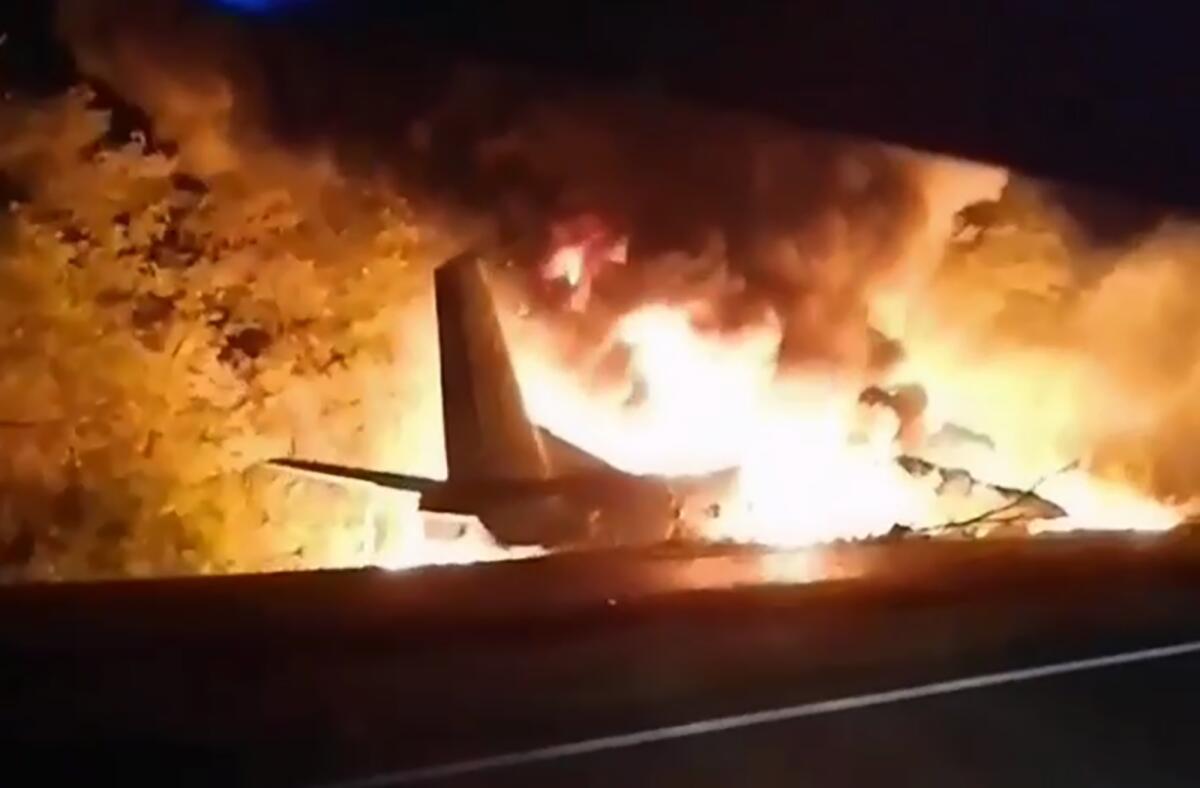 An image taken from video shows a military plane bursting into flames after crashing near Chuhuiv, Ukraine, on Friday night.