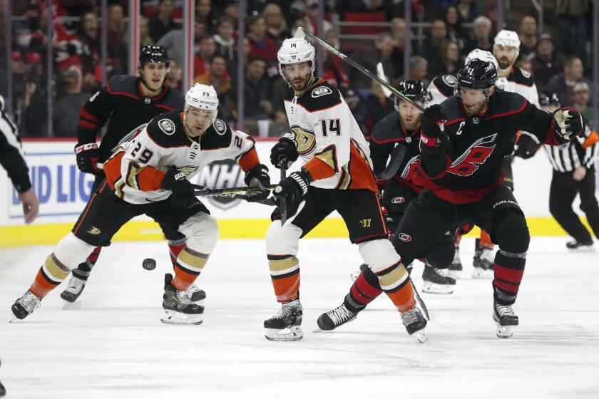 Anaheim Ducks center Devin Shore (29) and center Adam Henrique (14) chase the puck with Carolina Hurricanes center Jordan Staal (11) during the first period of an NHL hockey game in Raleigh, N.C., Friday, Jan. 17, 2020. (AP Photo/Gerry Broome)